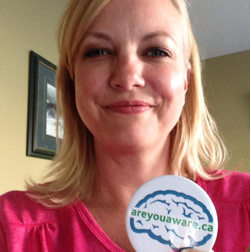 Tonya Flaming holds up an #areyouaware button