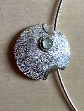 A silver round object with a round center