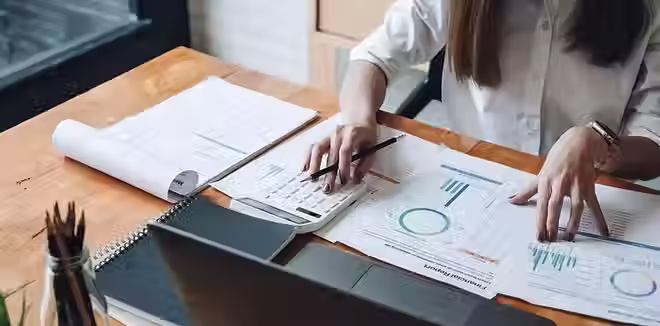 A woman examines the cost of doing business including her merchant account fees.