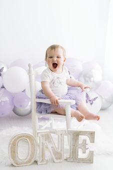 baby laughing on rocking chair during smash and splash session