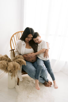 mother to be and son touching baby bump during lifestyle maternity session
