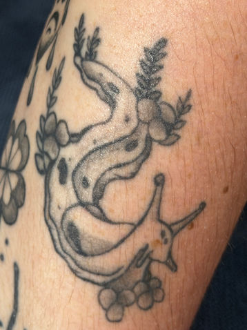 Black and gray banana slug flash tattoo by Calcium Tattoo in Eureka, California