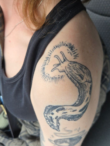 Medieval style banana slug tattoo by Calcium Tattoo in Eureka, California
