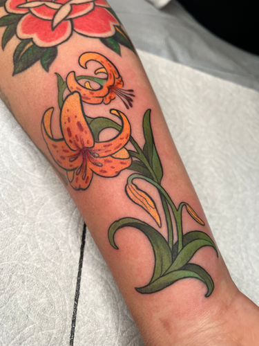 Neo-traditional style lilies in color done at Sangha Tattoo Studio by Calcium Art Tattoo in Eureka, California.