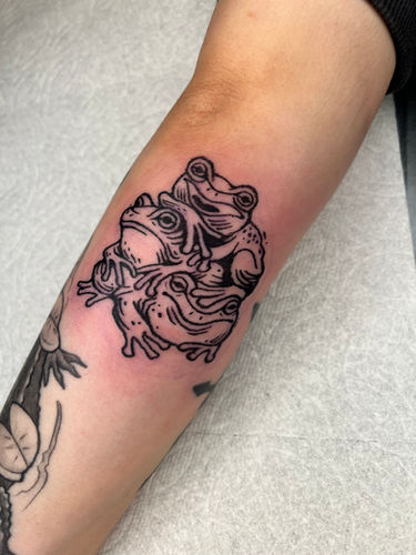 Linocut style tattoo of stacked frogs done at Sangha Tattoo Studio by Calcium Art Tattoo in Eureka, California.