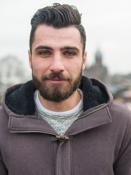 Portrait of a young male resident, symbolising strength and resilience in supported accommodation.