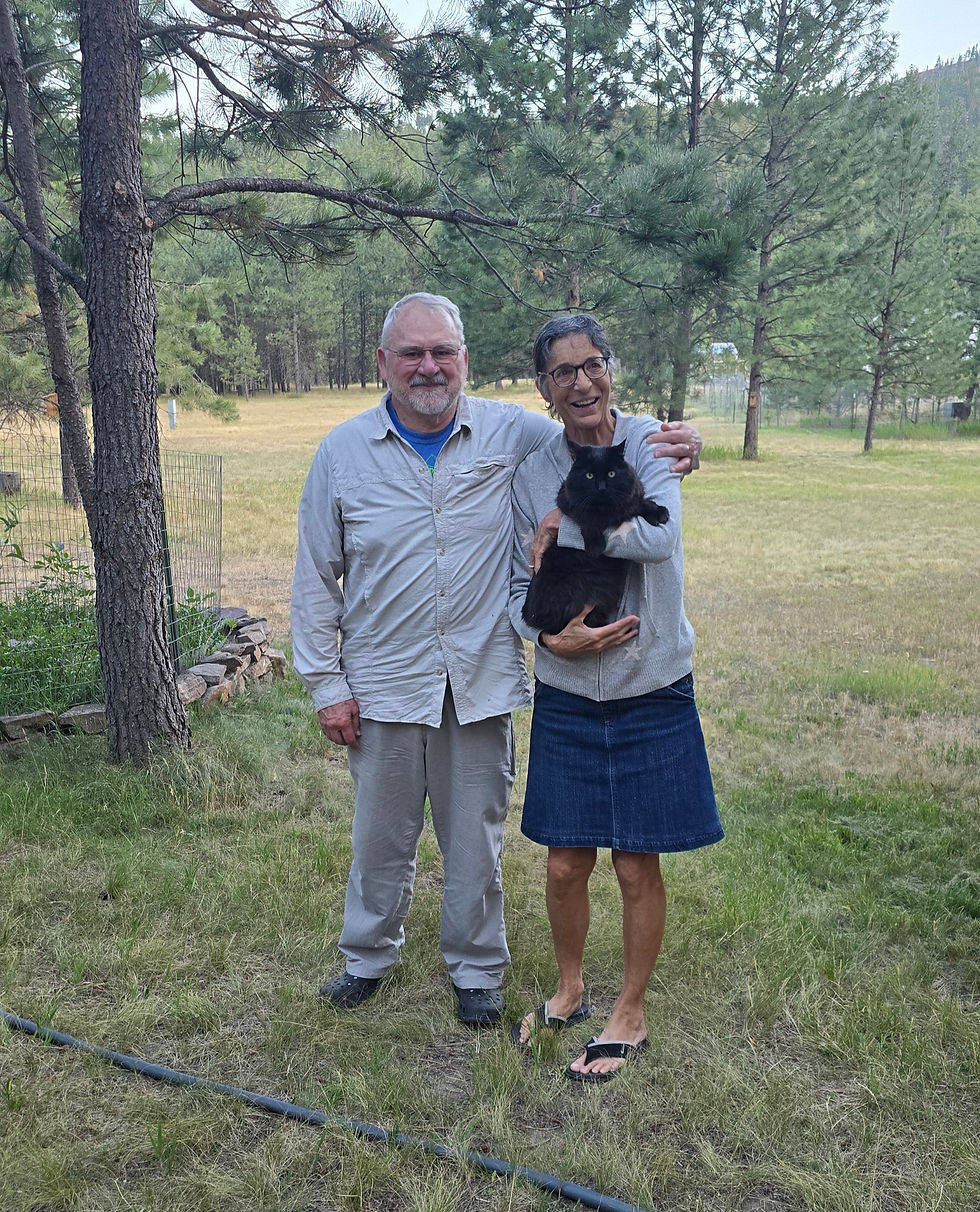 Lynn, John and the cat on their gorgeous property where they lived the last 35 years