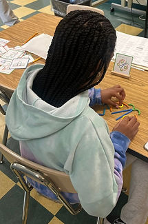 Empowering Consultants | Color image of girl engaging in an activity targeting fine motor and cognitive skills