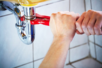 Plumber working on drain pipe