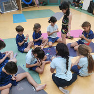 Children doing creative craft activity together on yoga mats — East West Yoga Kids Yoga Singapore school program
