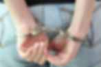 arrested female in handcuffs