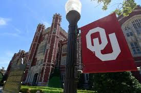 Big university of Oklahoma flag in front of university building
