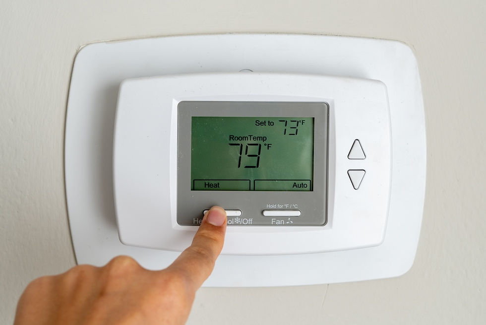 Finger presses a white wall thermostat showing 79°F room temp, set to 73°F, in heat mode.