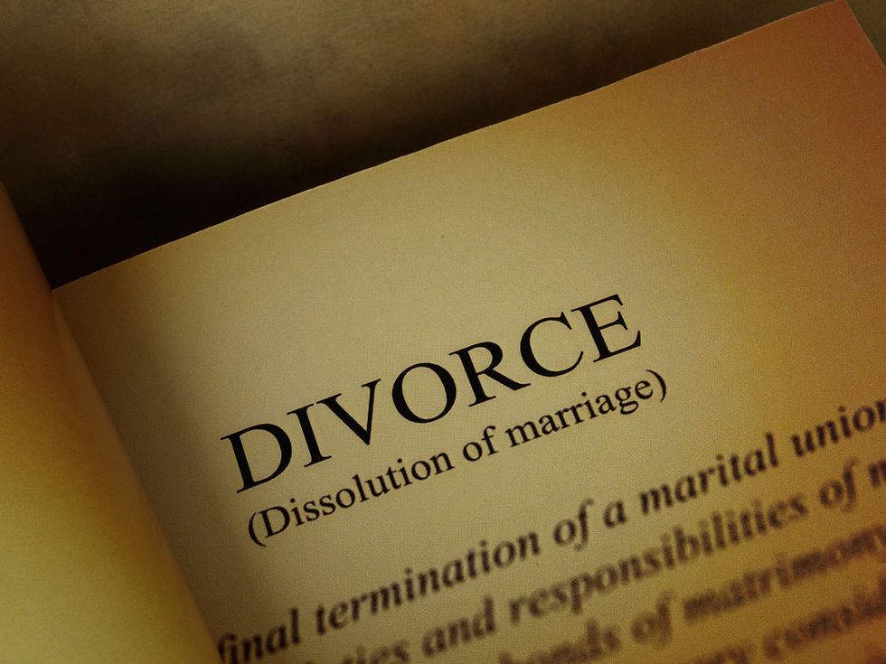 Close-up of a book page focusing on the word "DIVORCE" with the subtitle "Dissolution of marriage" in bold. Warm brown tones.
