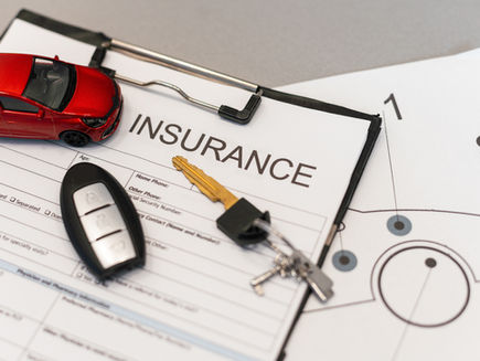insurance contract with car keys and model car