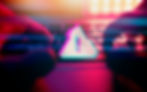 Hands typing on a keyboard with a pink and blue alert symbol overlay. Background has a neon red and blue glow, creating a tense mood.