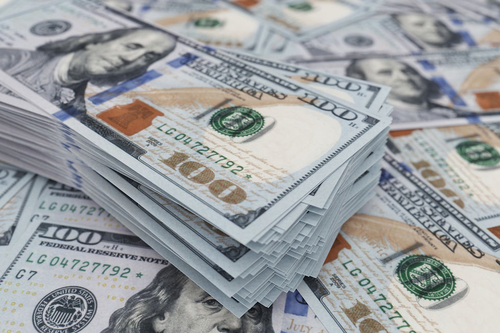Stacks of US $100 bills with Benjamin Franklin, Federal Reserve Note text visible, filling the frame.