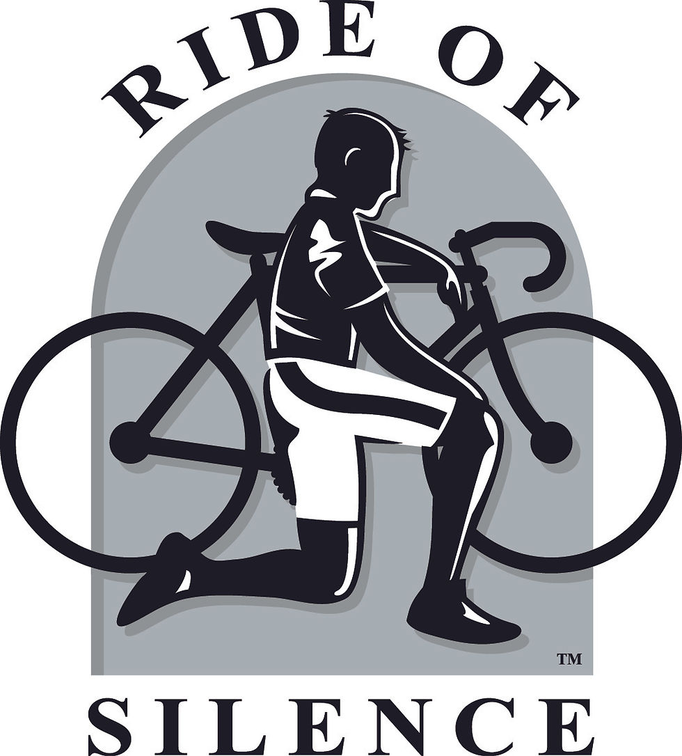A cyclist kneeling next to his bicycle.