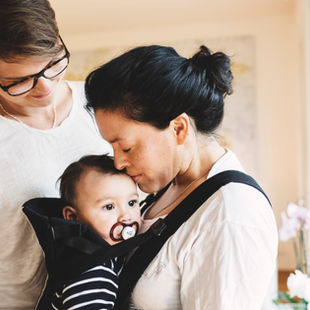 woman wearing a baby in a baby carrier
