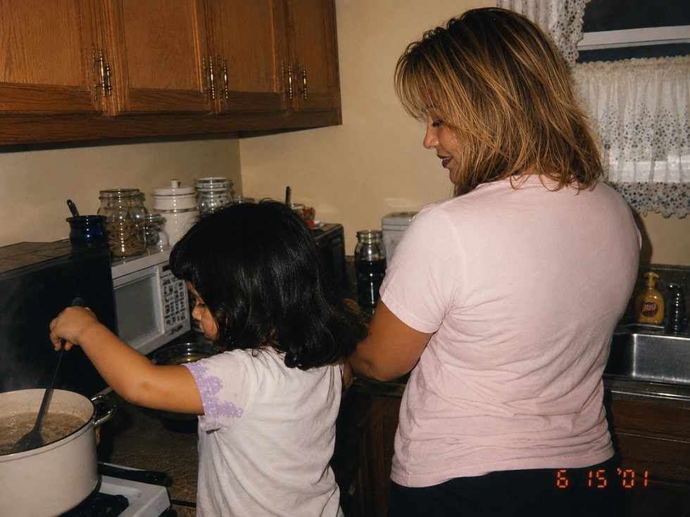 Eye-level view of a child helping in a cozy home kitchen.
