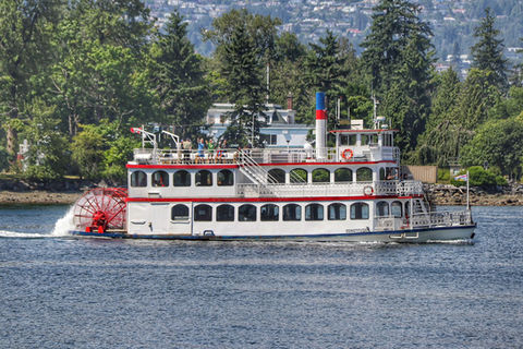 White and red boat propelled by a water wheel in Canada