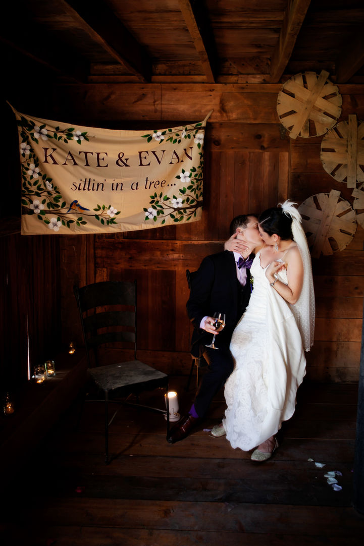 Unique barn wedding decor as bride and groom kiss-in private-stable-nook