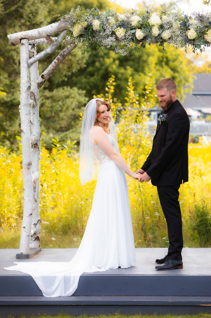 Bride and Groom's wedding ceremony in private meadow at Trent Lakes Golf Club