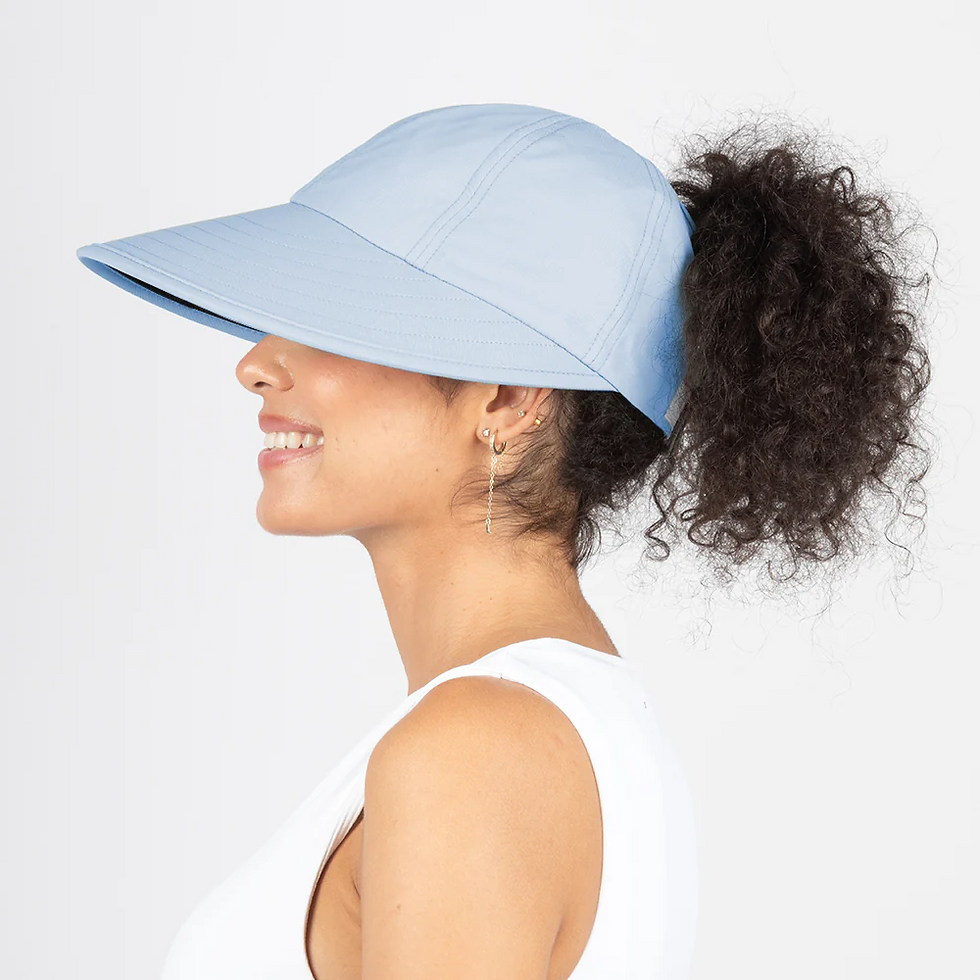 Thumbnail: Curly hair model wearing Ponyflo ponytail sunbloker wide brim cap in blue