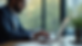 Eye-level view of a project manager using AI software on a laptop in a bright workspace