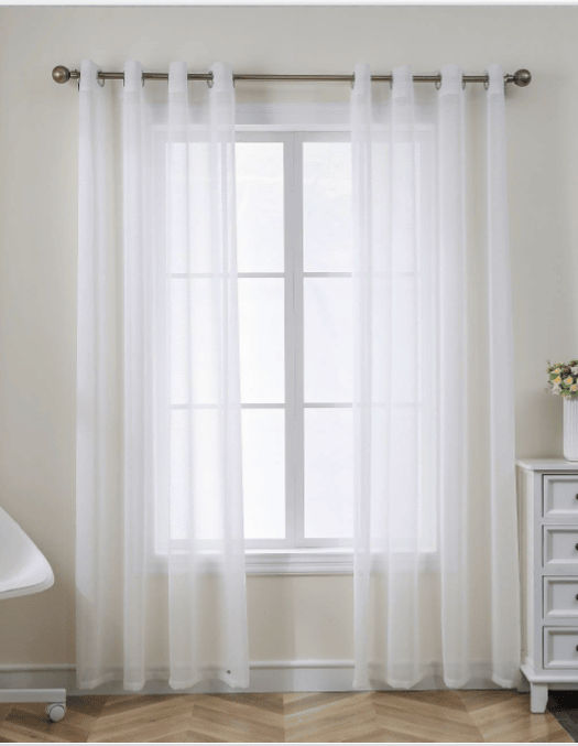 White sheer curtains on a window, white wall, white side table, and My Site 1