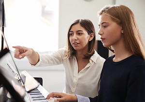 Teacher and Pupil at Piano Lesson