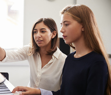 female teacher and student at piano lesson