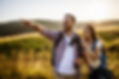 Happy couple is hiking in mountain They are watching nature with binoculars.jpg