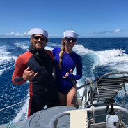 couple on a boat in custom freediving wetsuits