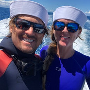 couple on a boat in custom freediving wetsuits