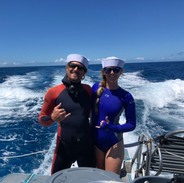 couple on a boat in custom freediving wetsuits