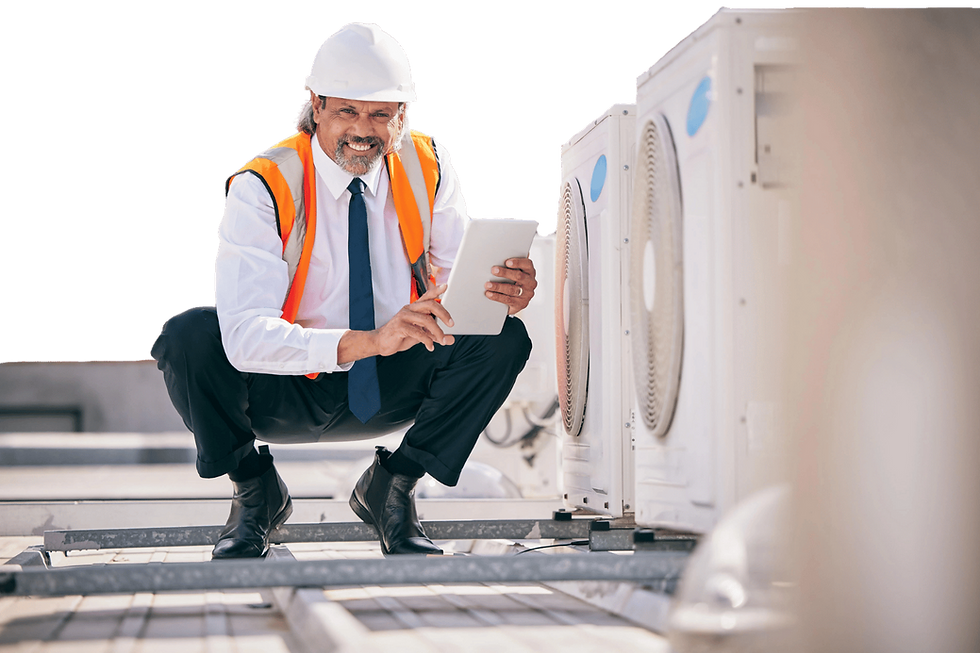 HVAC engineer squatting next to air conditioners