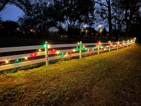 Multi-color christmas light installation on a fence in Marietta, GA