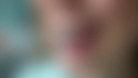 A patient using floss on their lower front teeth