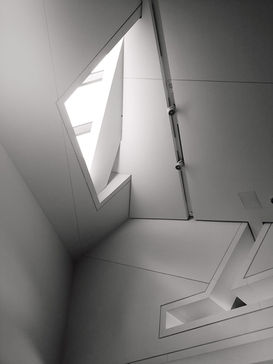 Architectural photography of walls and a skylight in B&W.
