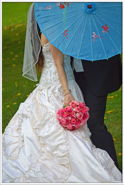 A Bride and Groom kissing.