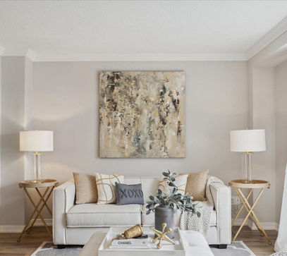 Beige couch in modern living room with abstract art.