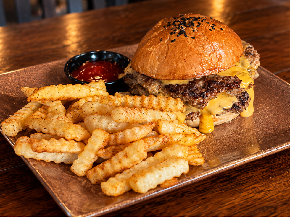 Smash burger with a large portion of crinkle cut fries in a pub in Ubud
