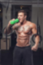 man with drink in gym for revenge body