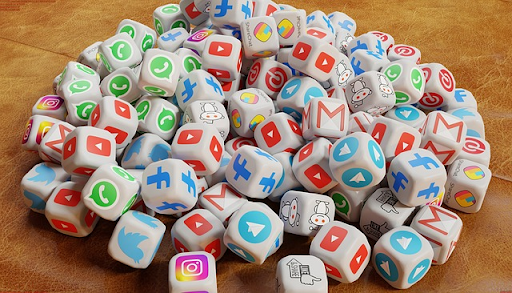 A heap of cubes with different symbols of social media logos on them