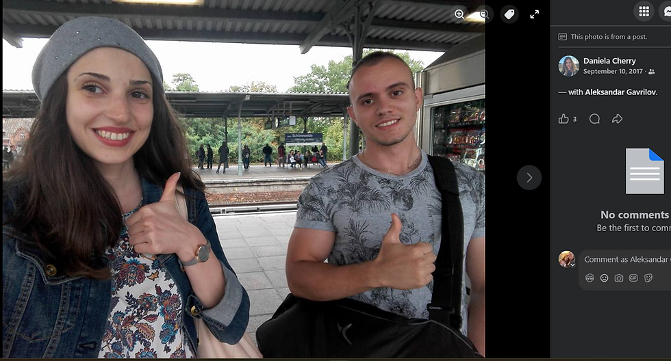 Alex Powerbuilding smiling and giving thumbs up at a train station. One wears a floral shirt; the other, a denim jacket and gray cap. "Schöneweide" sign visible.