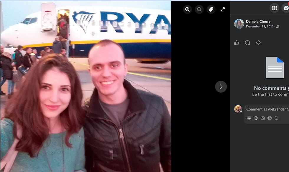 A smiling Daniela and Alex Powerbuilding pose for a selfie in front of a Ryanair plane. People board in the background. Sky is dusk-lit.
