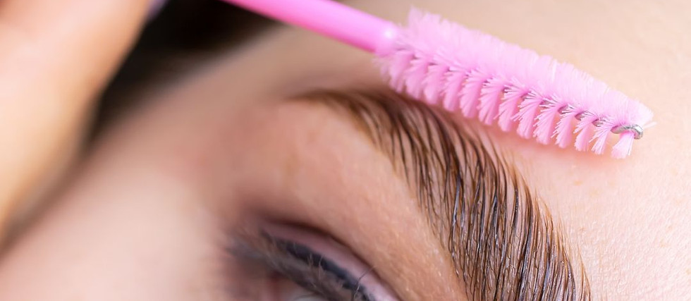 Gestylte Augenbraue mit pinker Bürste bei Brow Lifting Behandlung in Nahaufnahme