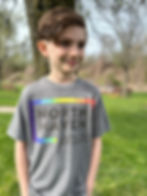 Child wearing gray North Haven Pride shirt and smiling