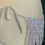 Thumbnail: Back lacing detail of holographic white showgirl costume